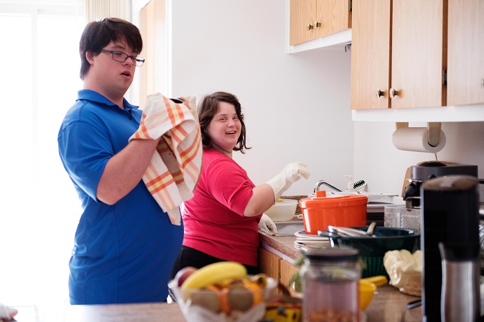 Couple with intellectual disability working together in their kitchen